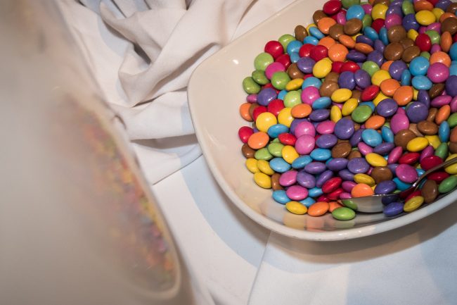 Bowl With Smarties At A Kids Party On A White Cloth With Reflect
