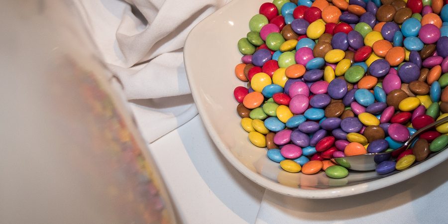 Bowl With Smarties At A Kids Party On A White Cloth With Reflect